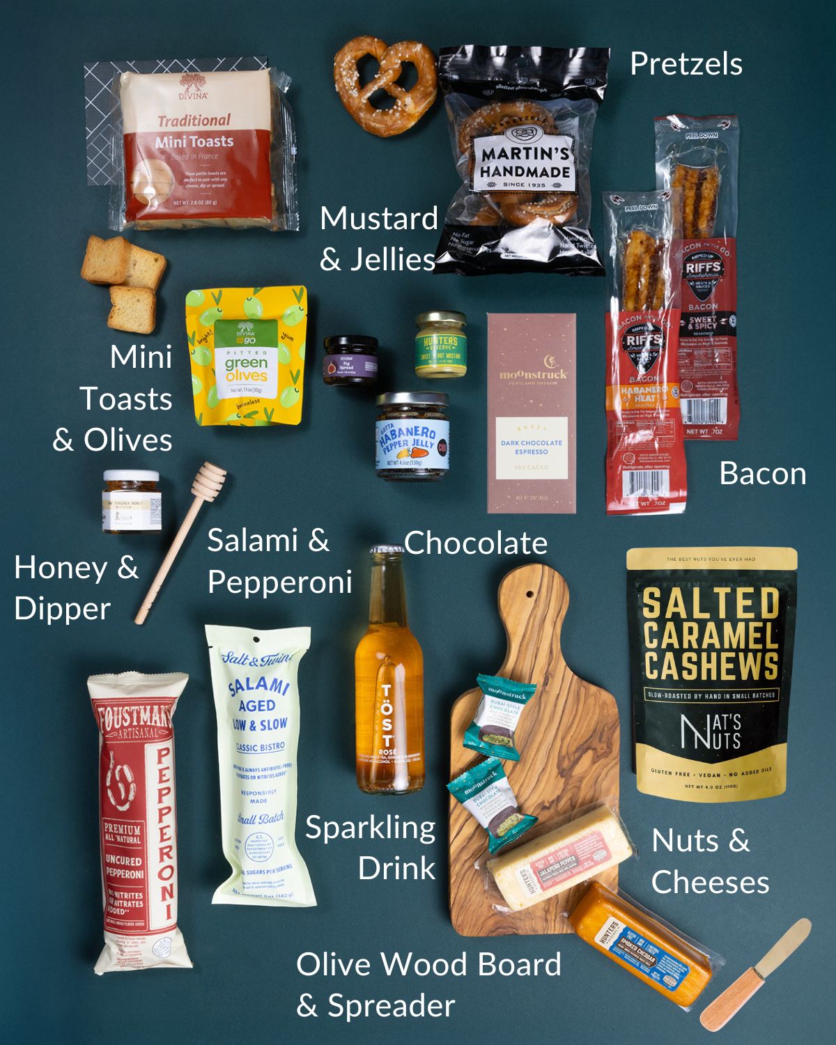 Charcuterie-in-a-Box set with olive wood board, assorted cheeses, cured meats, gourmet snacks, and sparkling beverage.