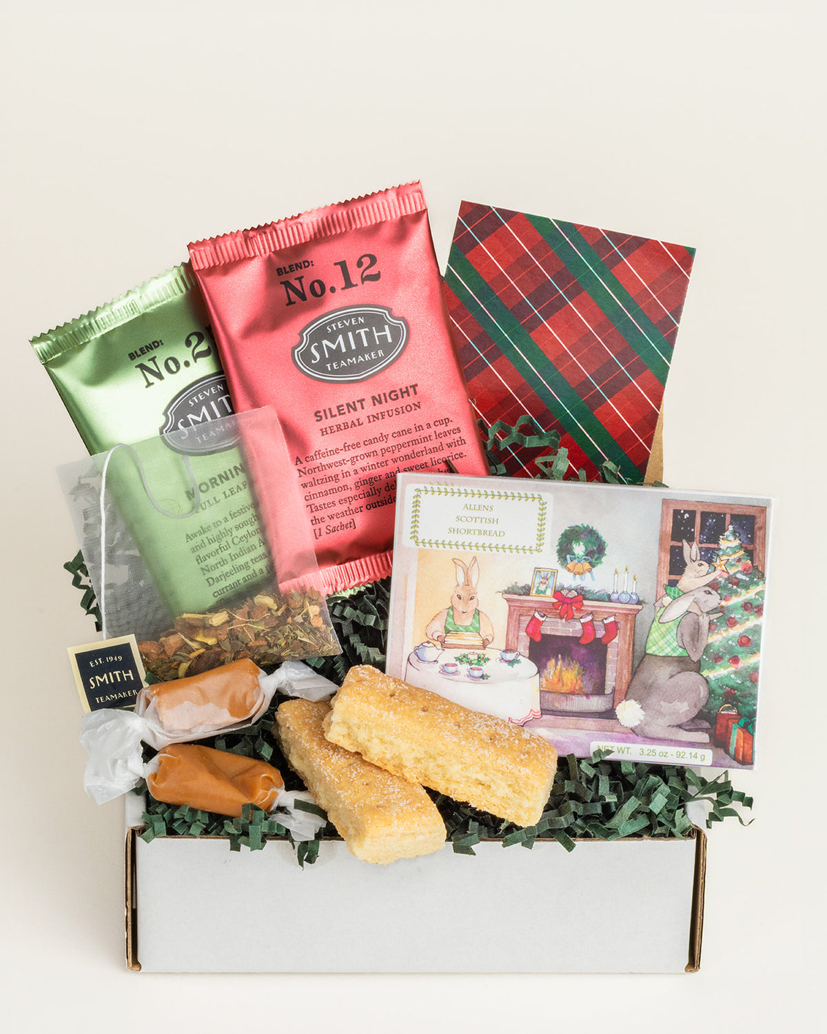 Christmas gift box with Smith tea packets, two caramels, shortbread cookies, and a festive rabbit-themed cookie box.