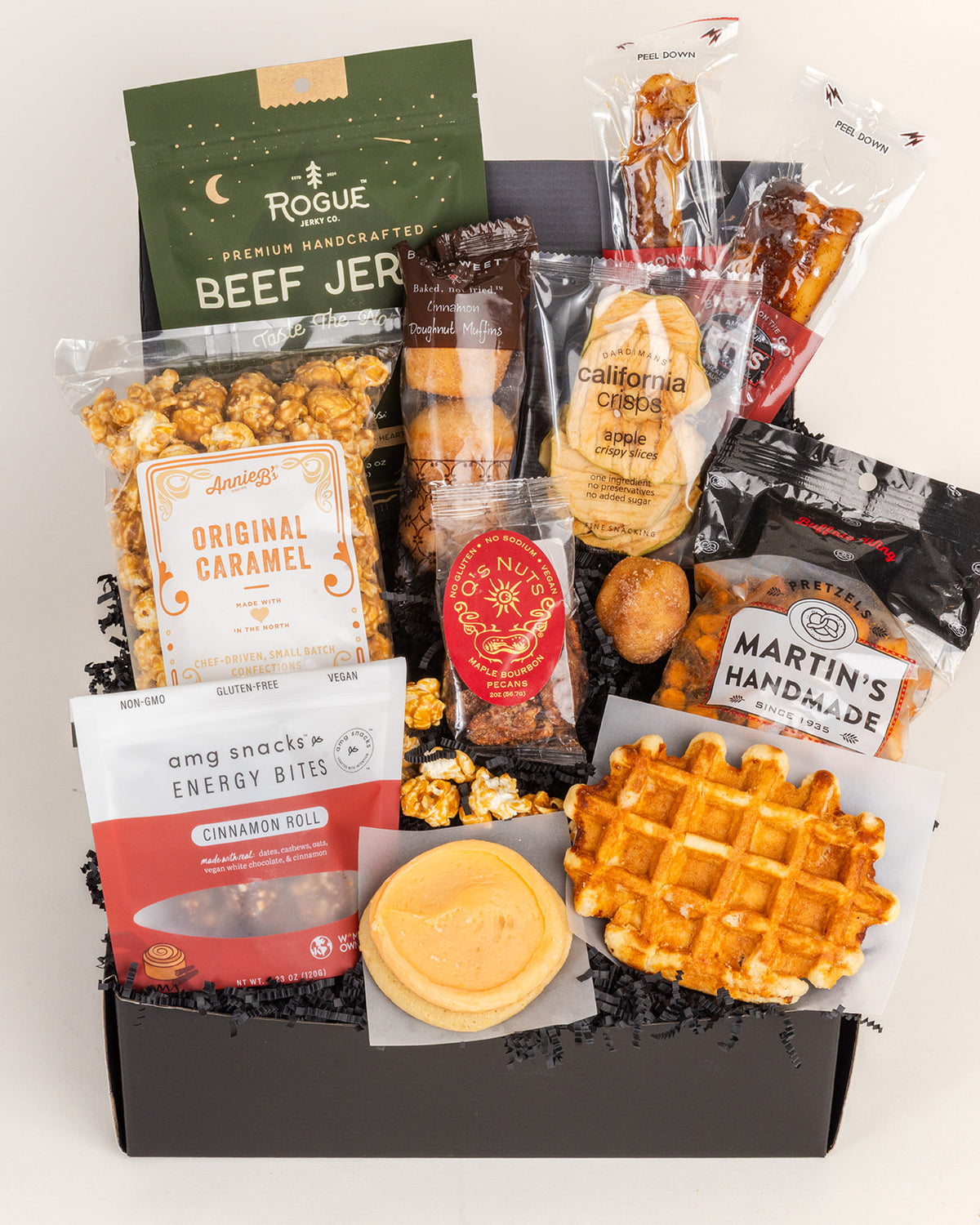 Foodie Delight gift box filled with beef jerky, caramel popcorn, apple crisps, a waffle, cookie, and assorted savory snacks.