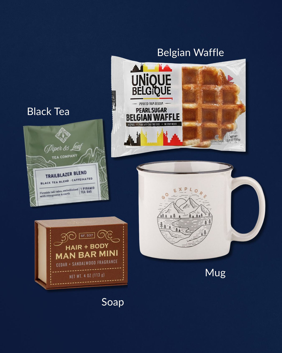 Gift set with a Go Explore ceramic mug, Trailblazer black tea, Belgian waffle, and a cedar sandalwood mini soap bar.