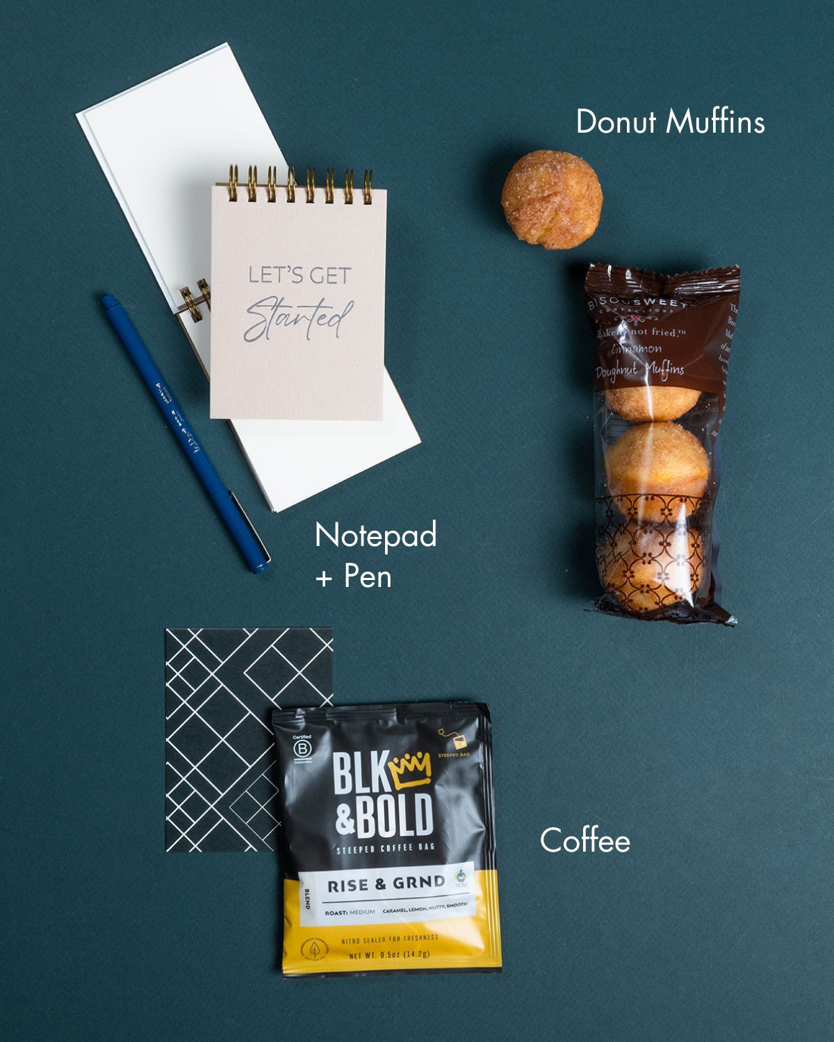 Let’s Get Started gift box with cinnamon donut muffins, a branded notepad, a blue pen, and a BLK & Bold coffee steep bag.