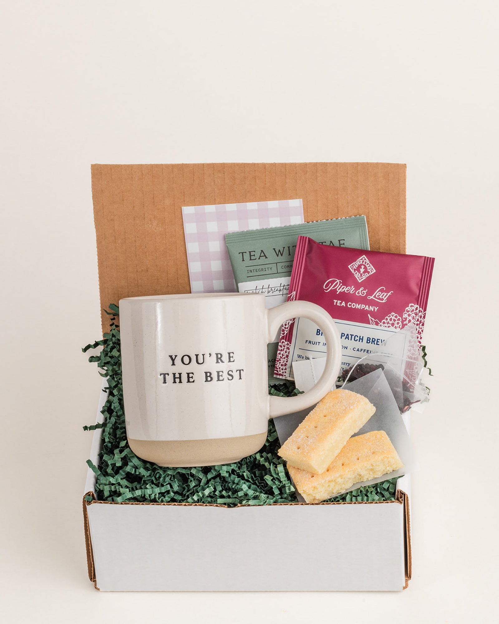 Mugful of Delight gift set featuring a "You're the Best" mug, tea, and treats in a decorative box.