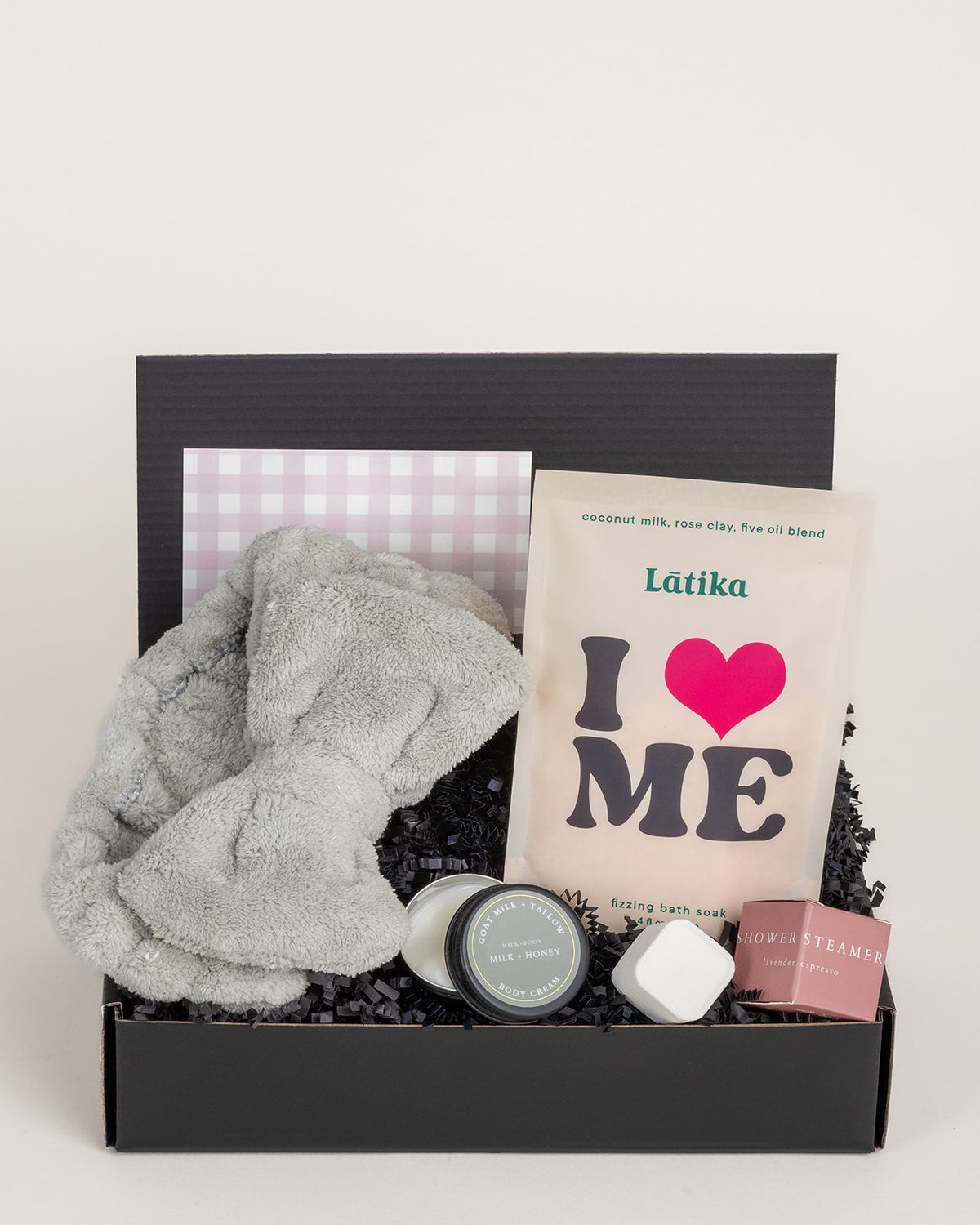 Pamper gift box with a grey spa headband, Latika bath soak, tallow body cream, and a lavender shower steamer.
