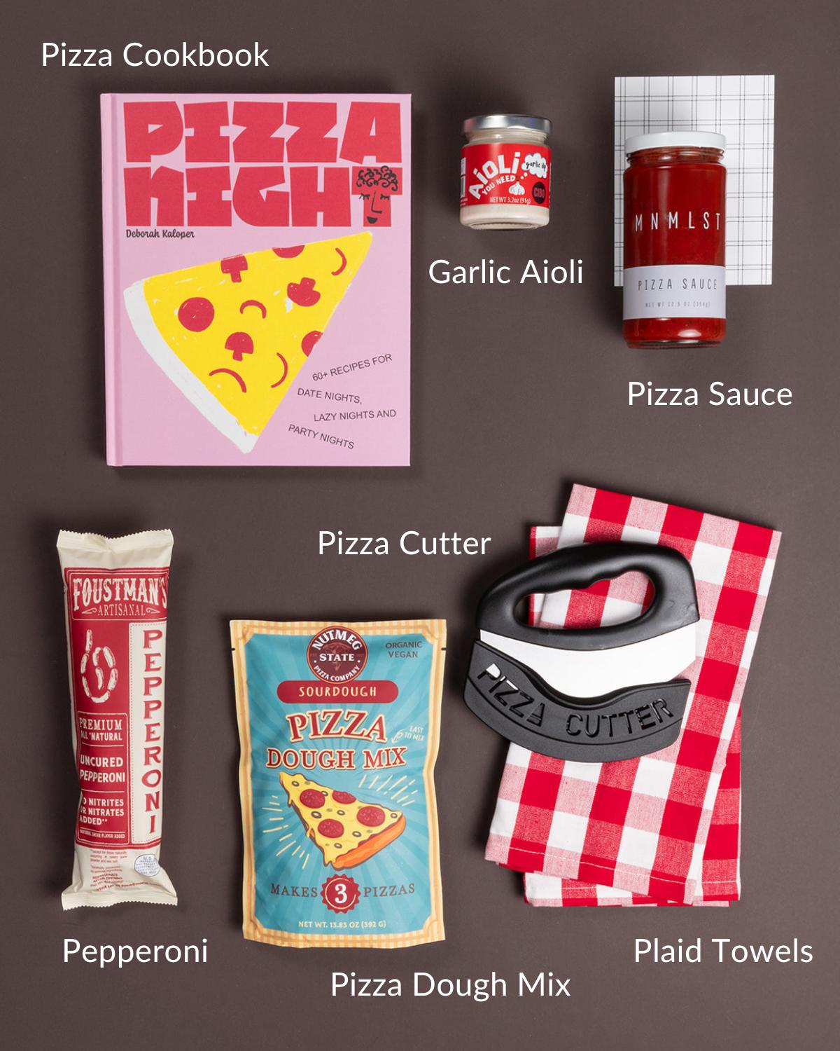 Pizza Night kit featuring a cookbook, sourdough dough mix, pepperoni, pizza sauce, garlic aioli, a pizza cutter, and plaid towels.
