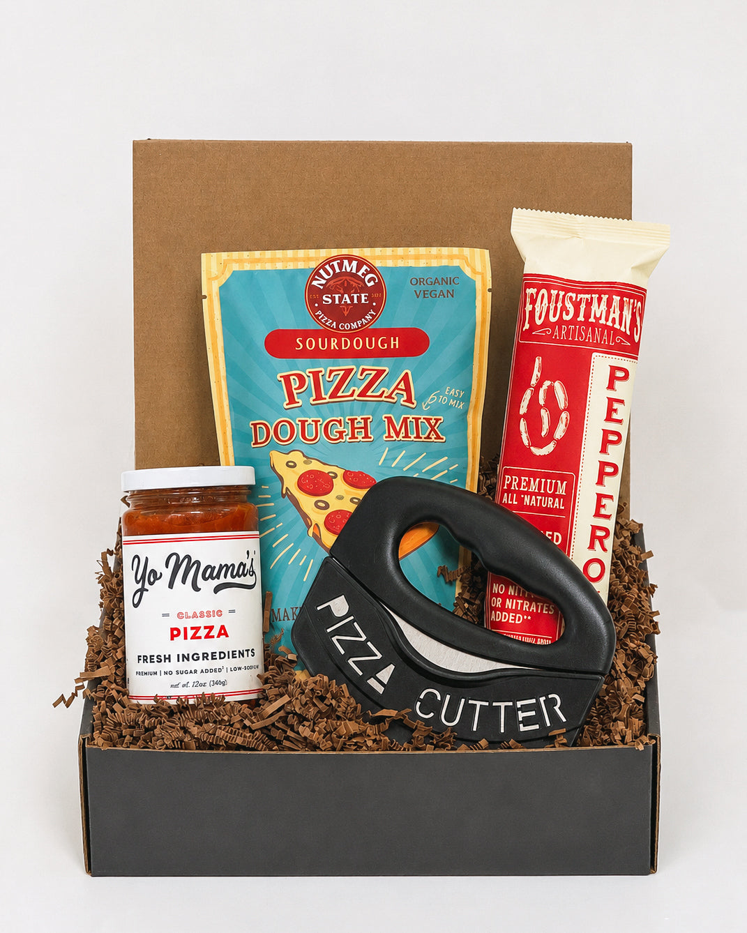 Pizza Night gift box containing sourdough dough mix, pepperoni, pizza sauce, and a black ergonomic pizza cutter.