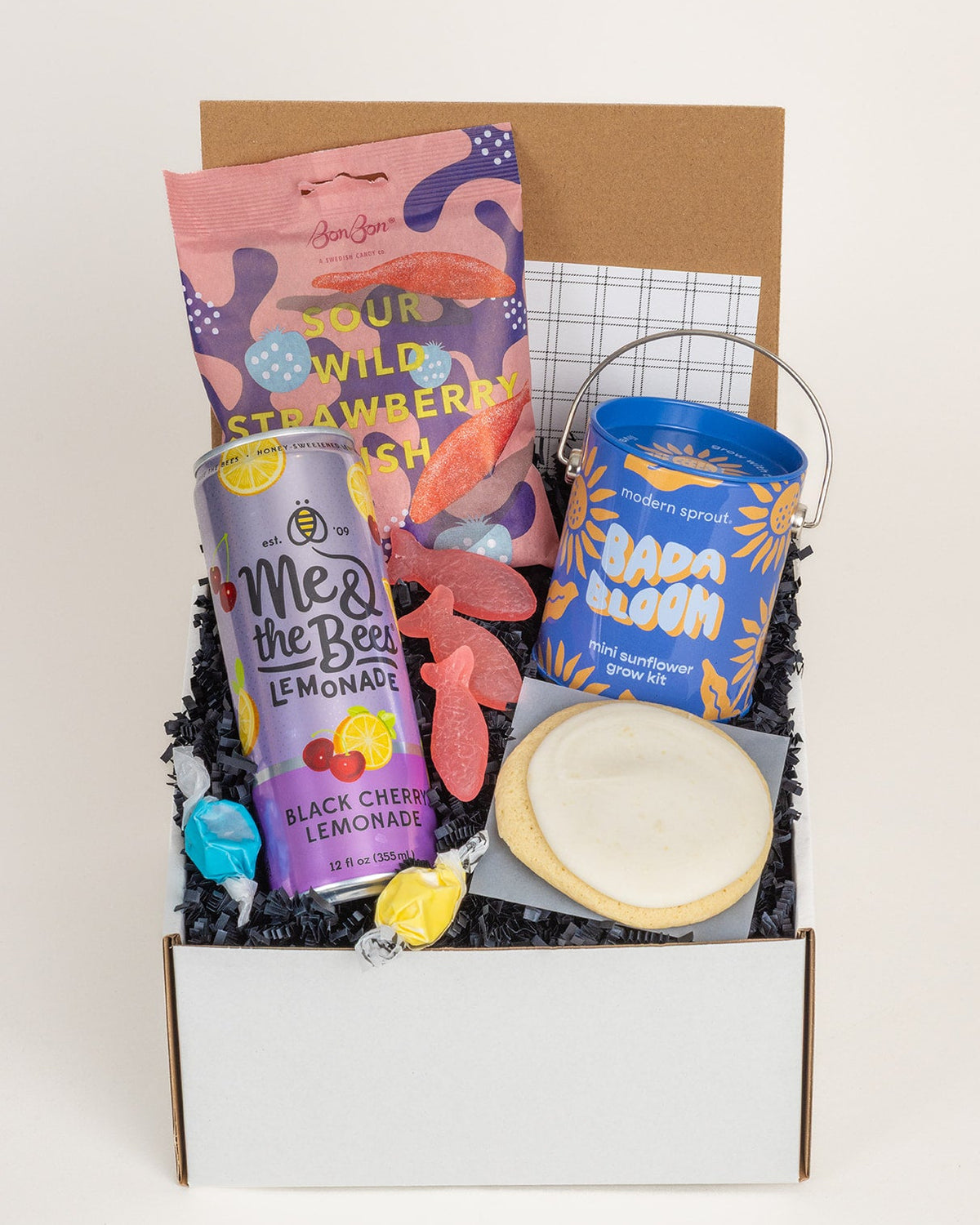Summer & Sunshine gift box with black cherry lemonade, sour gummies, a lemon cookie, and a sunflower grow kit.