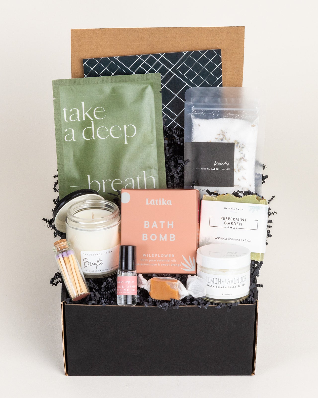 Rest & Relaxation gift box with bath bomb, candles, and soothing scents for a calming experience.