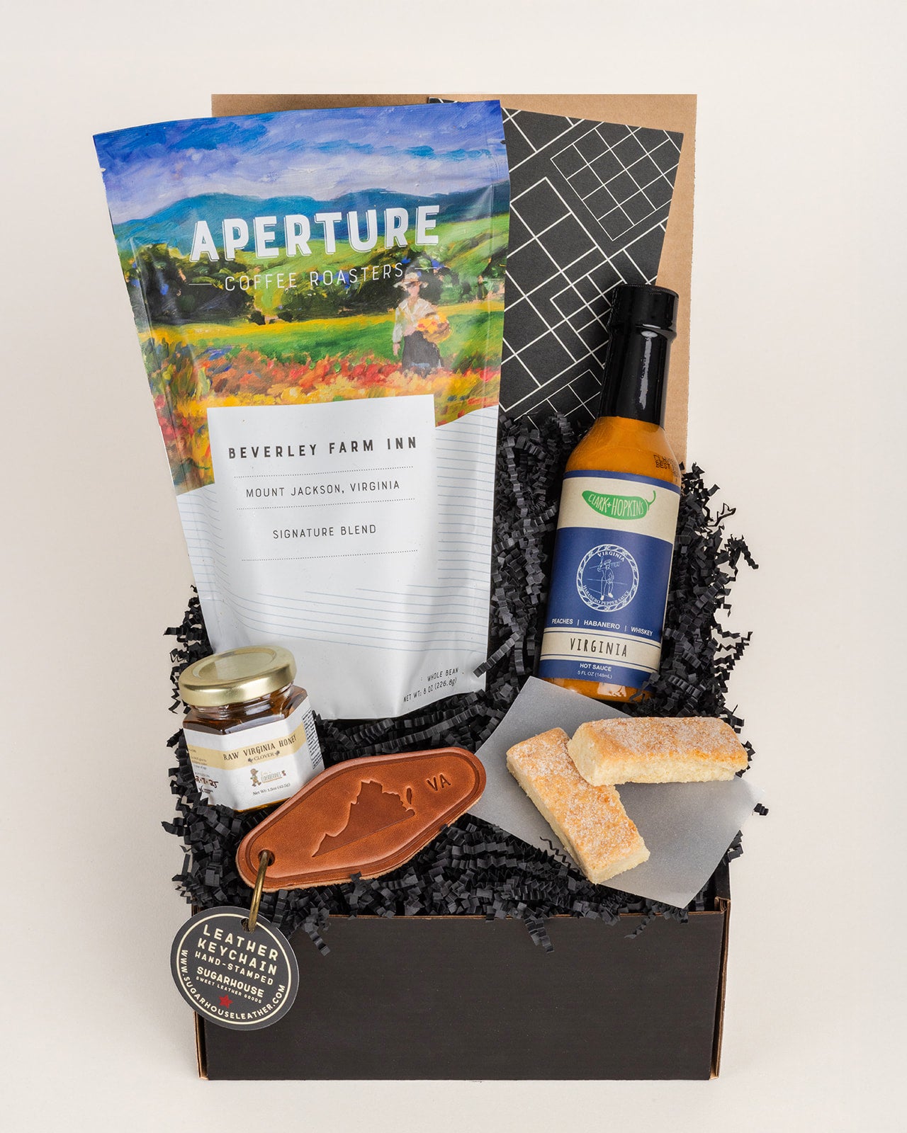 Virginia gift box featuring Aperture coffee, Clark & Hopkins hot sauce, raw honey, shortbread cookies, and a leather keychain.