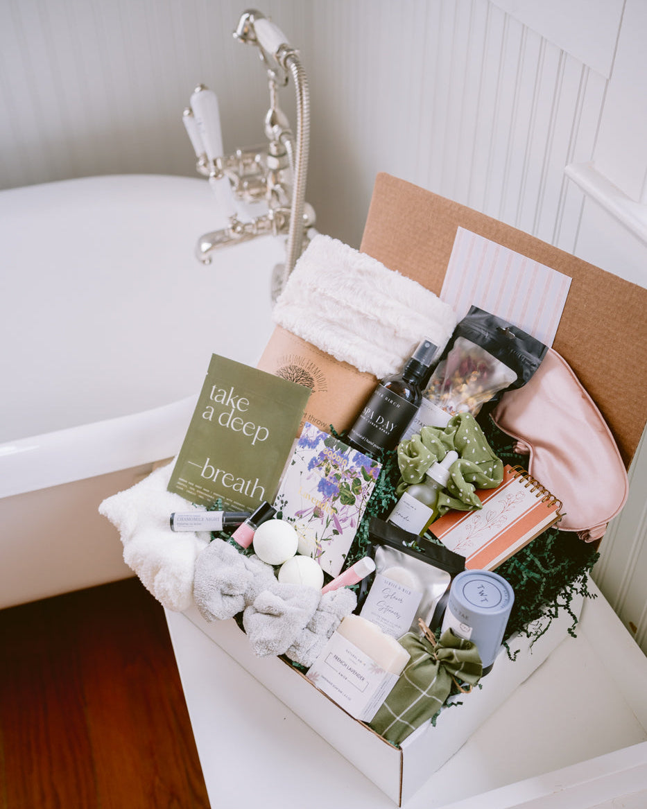 Ultimate Spa Day gift box featuring a faux fur blanket, bath bombs, skincare products, and a silk eye mask in a white box.