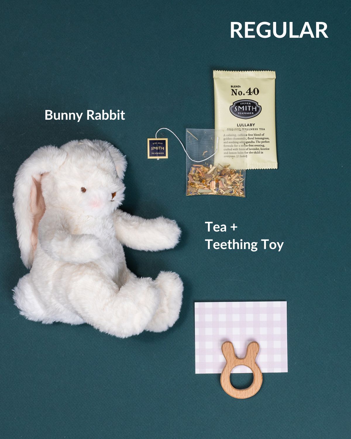 Welcome, Baby gift set featuring a bunny rabbit plush, tea, and a wooden teething toy on a green background.