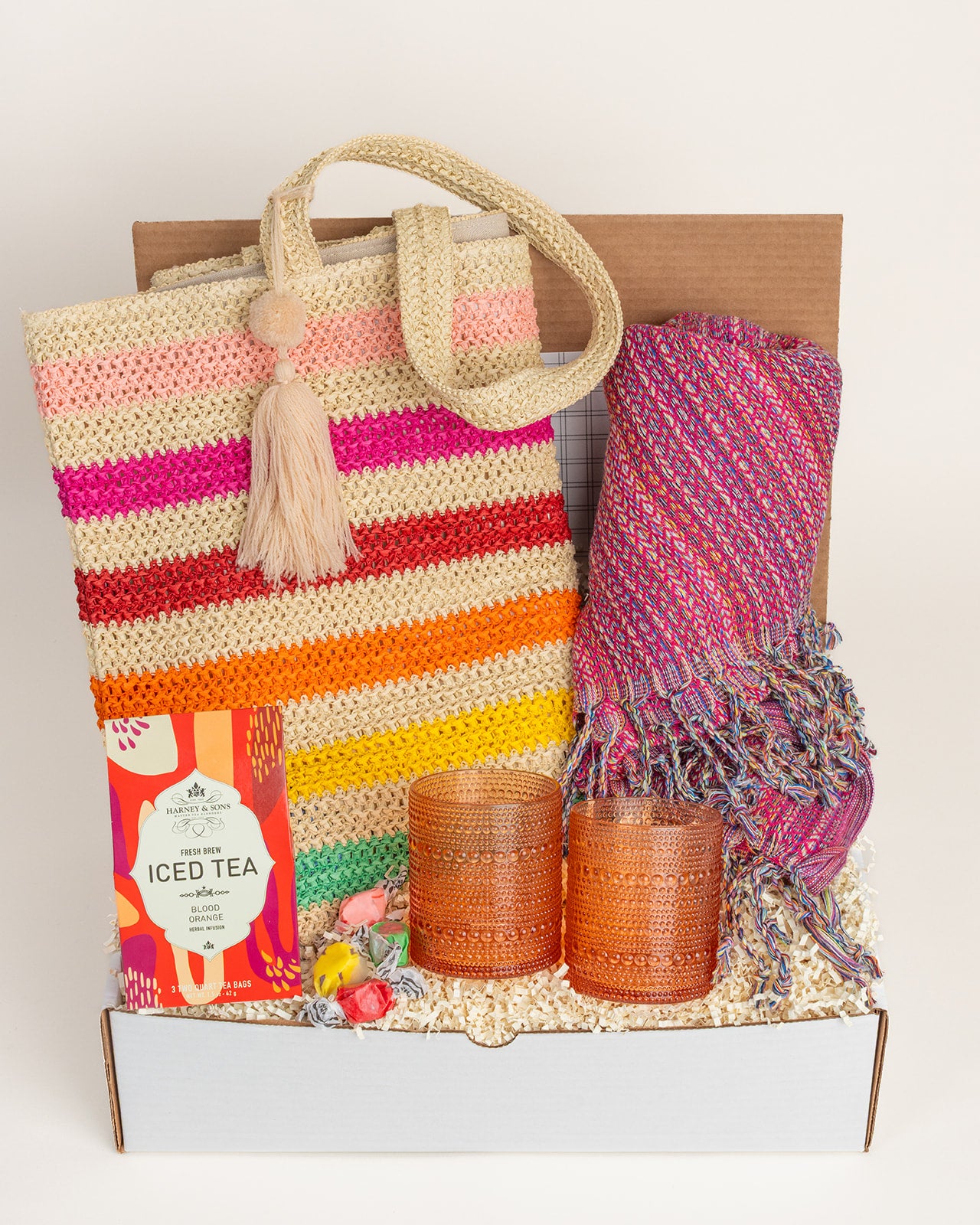 Beach Fun gift set featuring a colorful tote, cozy blanket, iced tea, and decorative candles.