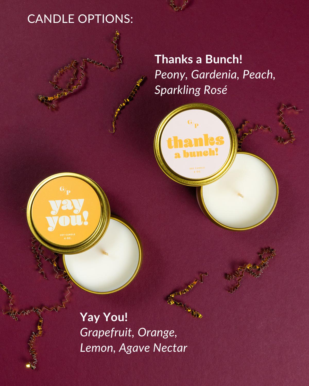 Celebrating You candles in gold tins with scents of grapefruit, orange, lemon, and agave nectar on a burgundy background.
