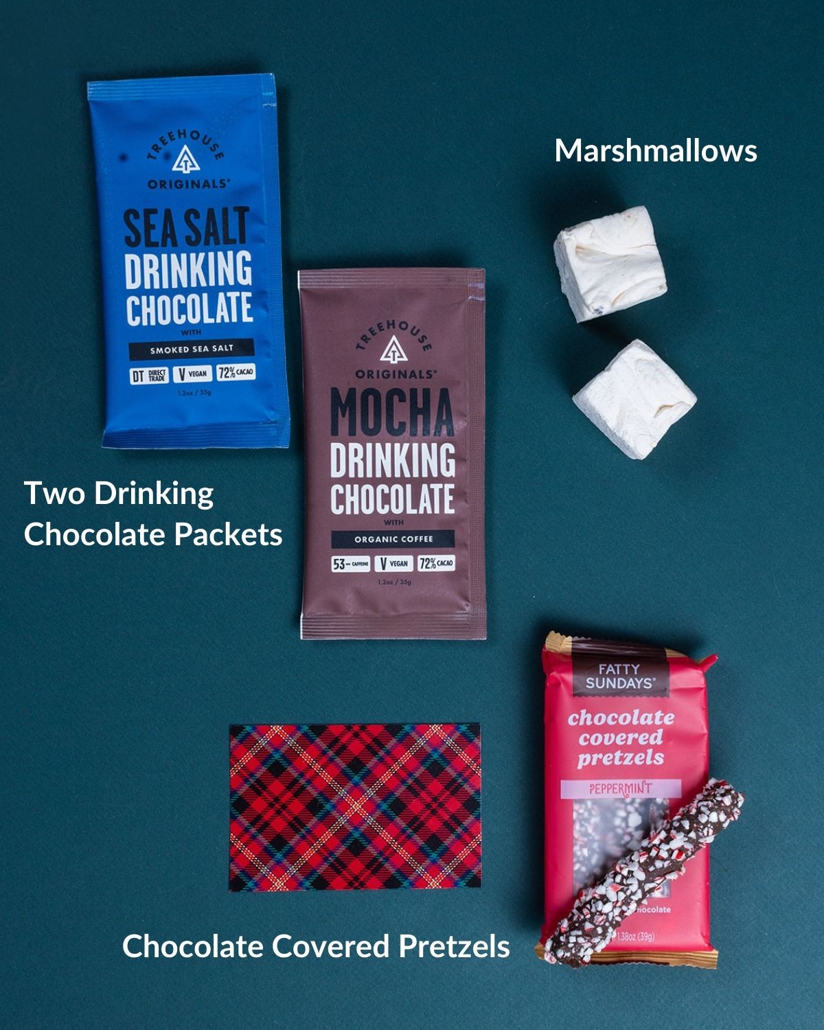 Cheery Hello gift set with drinking chocolate, marshmallows, peppermint pretzels, and a red plaid note on dark green.