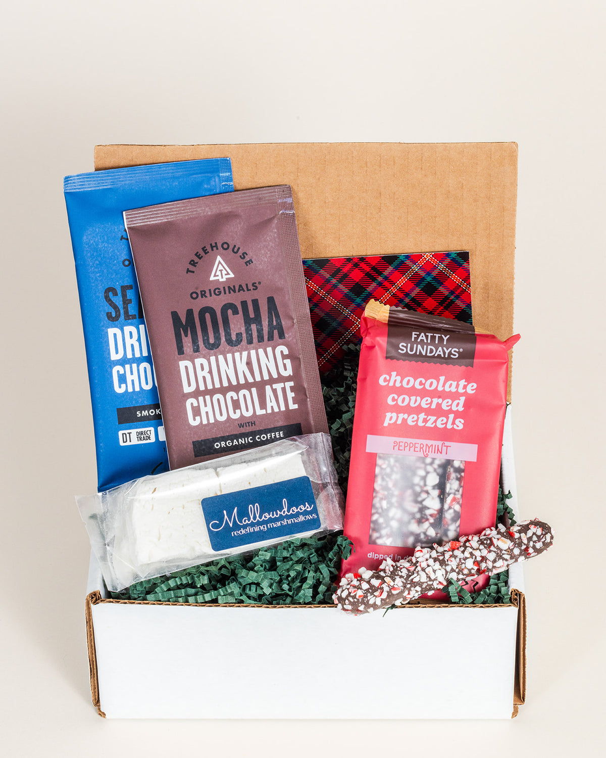 Cheery Hello gift box with mocha drinking chocolate, peppermint pretzels, and handcrafted marshmallows on green filler.