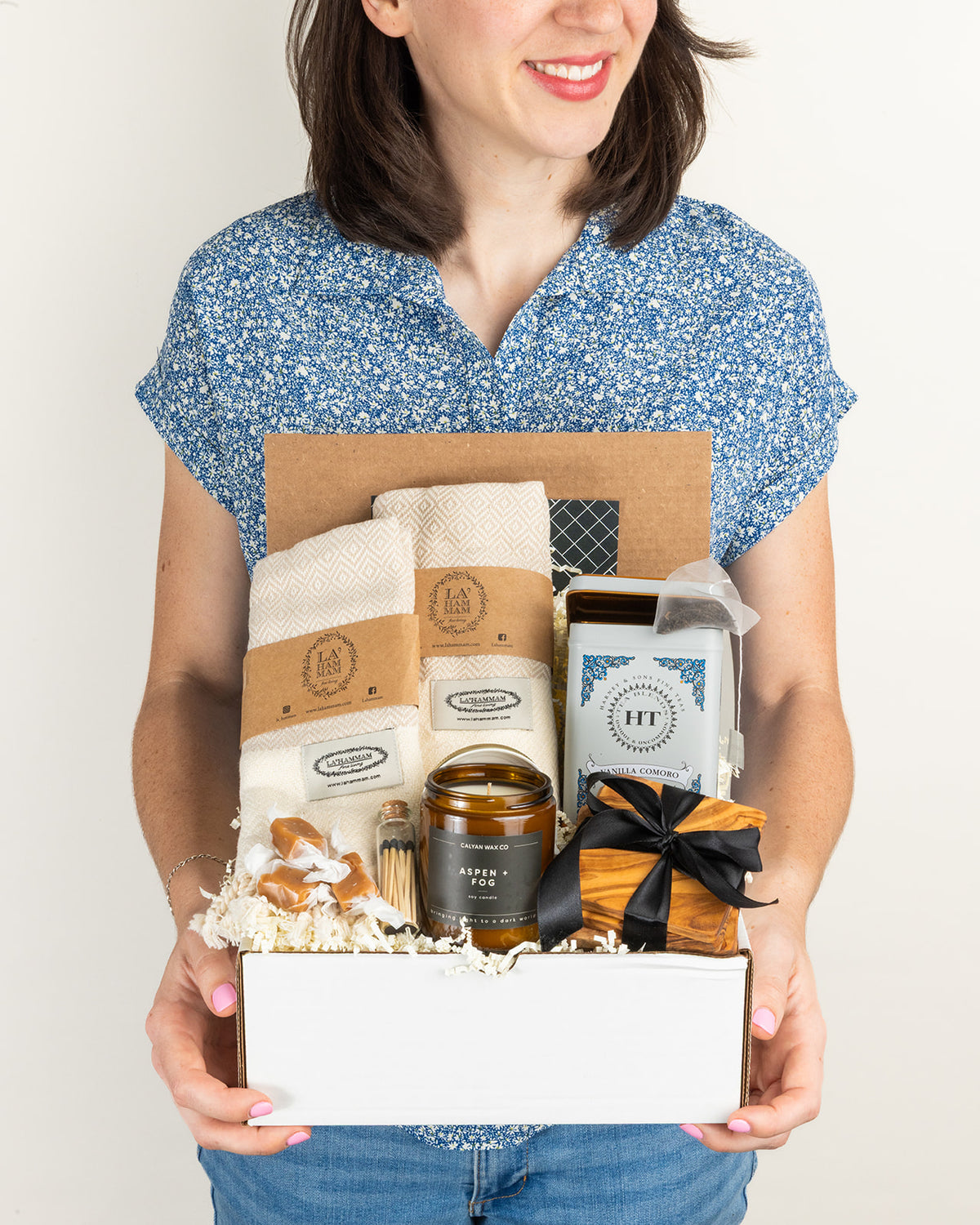 Welcome Home gift box featuring cozy items, a candle, and matches, perfect for Christmas shipping.